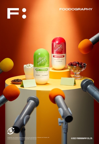 This advertisement features two pill-shaped dietary supplement containers placed on a yellow pedestal surrounded by multiple microphones, creating a high-authority interview aesthetic.